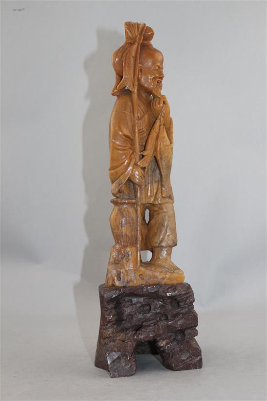 A Chinese soapstone figure of a fisherman, early 20th century, 36cm.